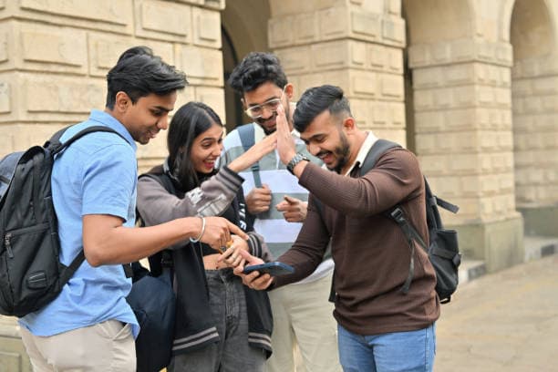 A group of students enjoying campus life outside an academic block