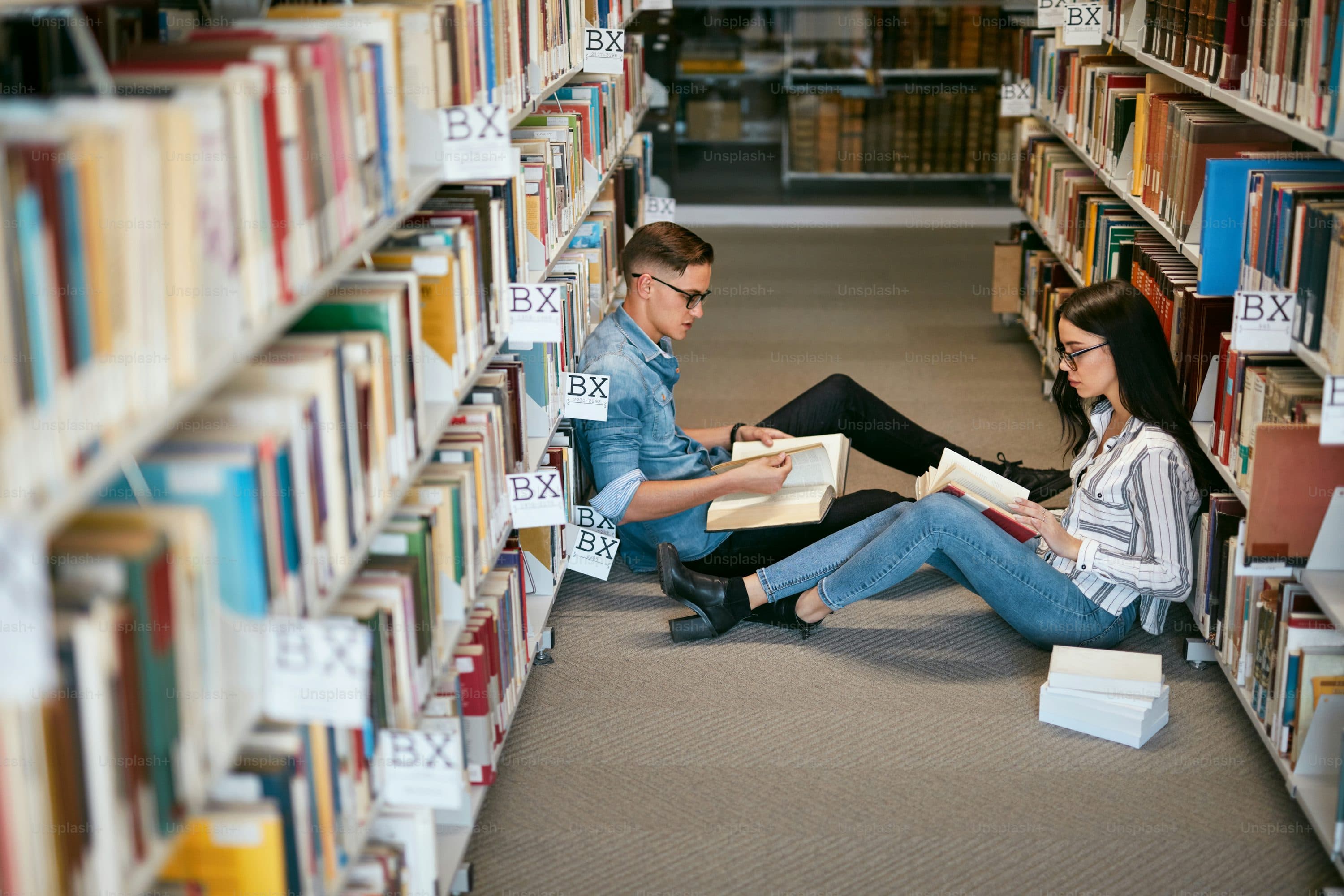 Students studying in a classic university library at night