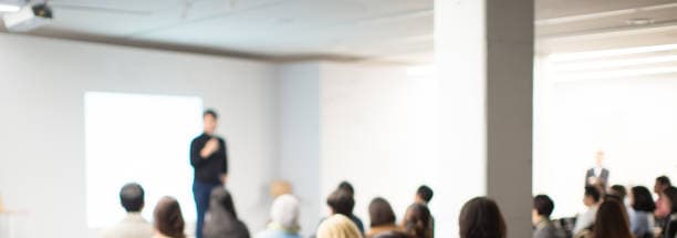 Audience listening to a speaker at a networking seminar