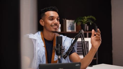 A young creator recording a podcast in a home studio