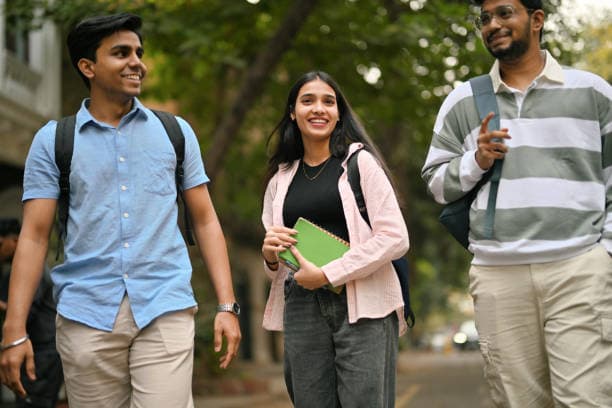Students walking across a green university campus