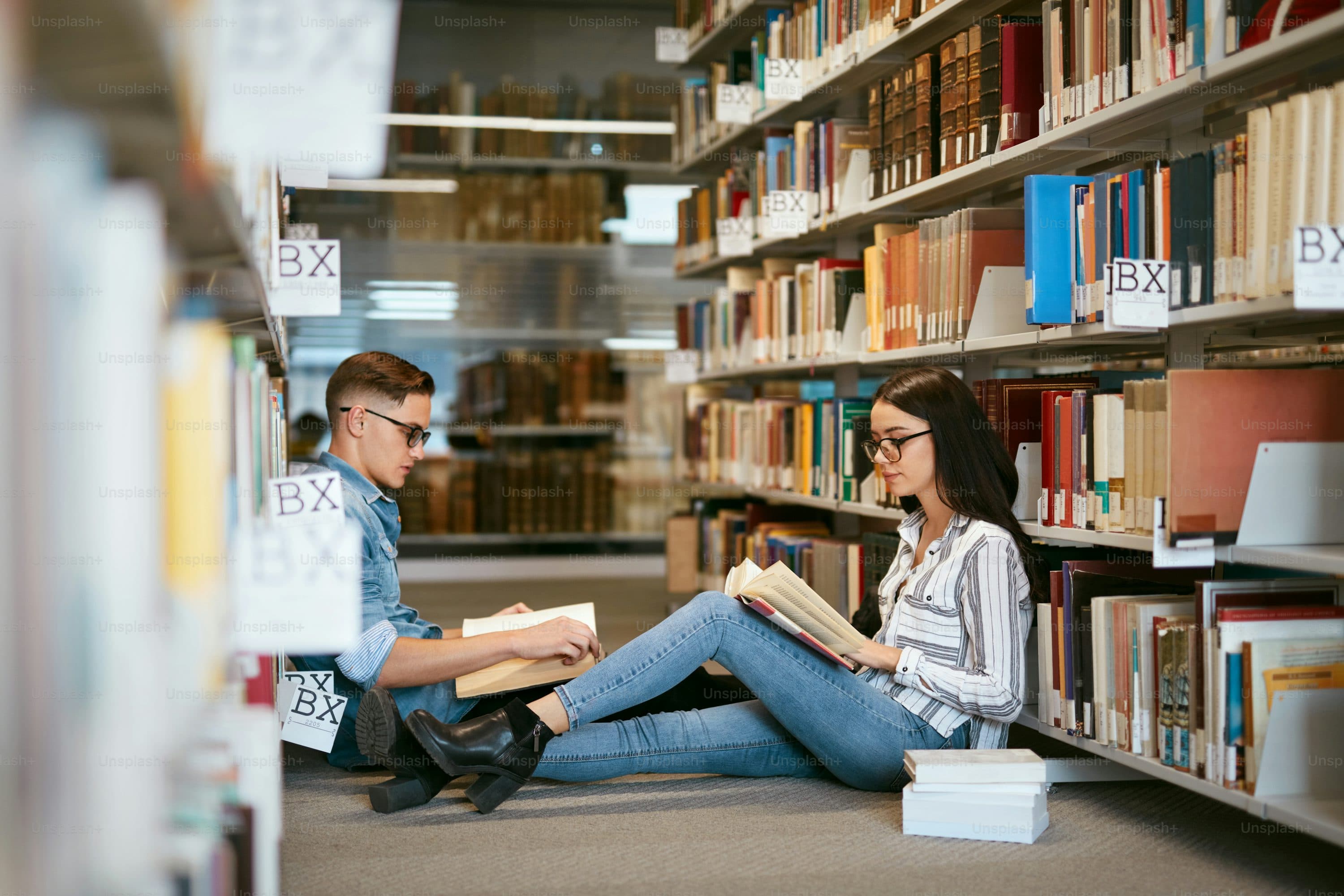 A student studying alone late at night in a warm library