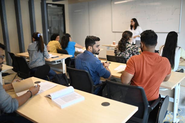 An instructor engaging with students in a classroom